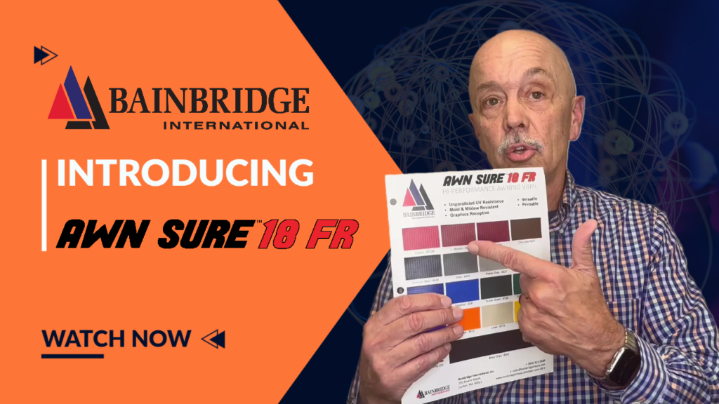 A man holding up a book with the words " bainbridge international introducing the sure 1 8 fr."