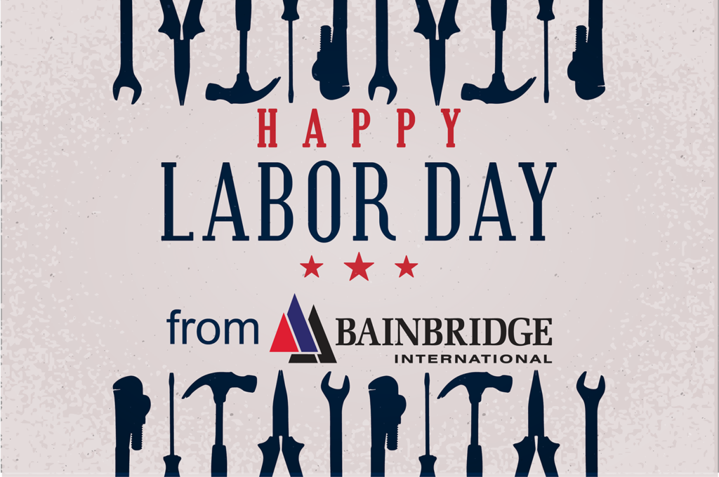 A bunch of tools are on the ground with words that say happy labor day from bainbridge international.