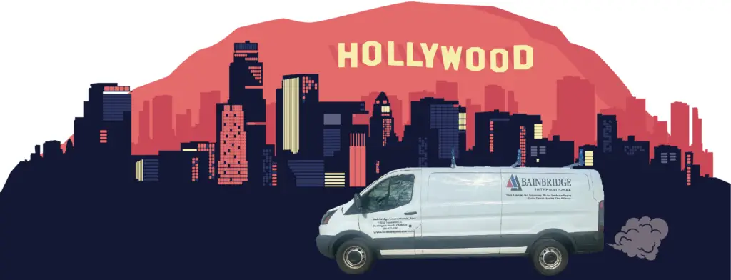 A van parked in front of the hollywood sign.